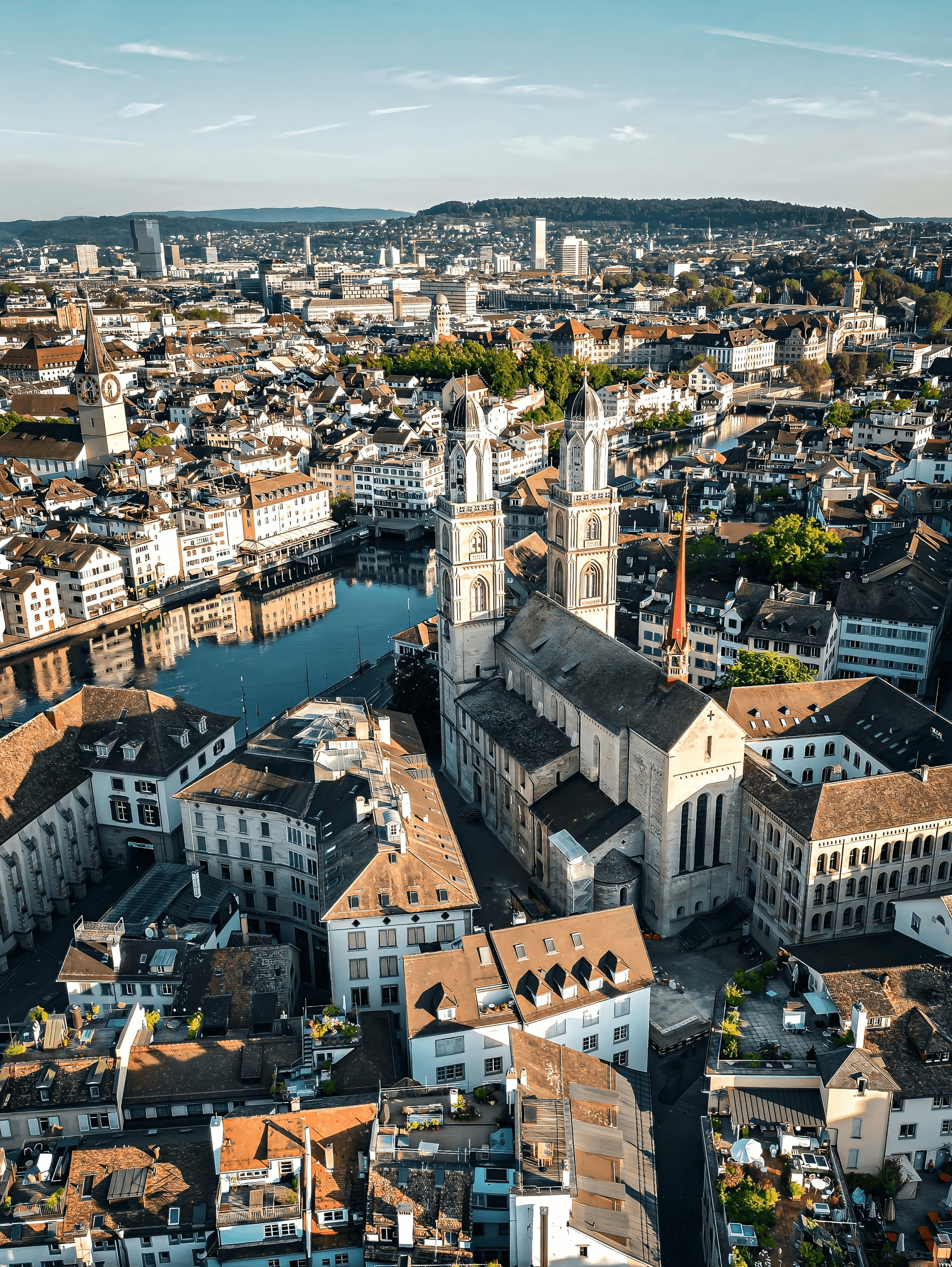 Aerial view of Zurich's Old Town with Grossmünster Church, the Limmat River, and historic buildings.